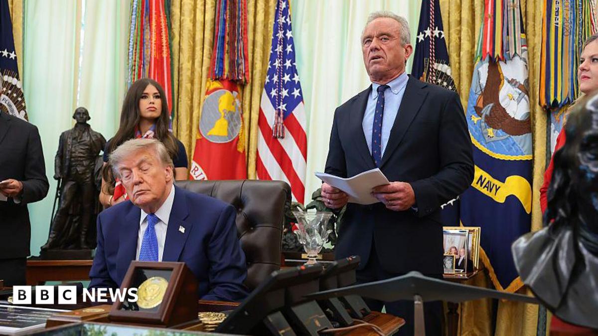 Donald Trump speaks from a lectern during a news conference at the White House. He is accompanied by Robert F Kennedy Jr.